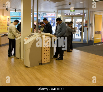 Jobseekers looking for work using Jobpoints Jobcentreplus office Kentish Town London Stock Photo