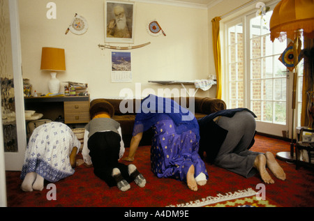 A Sikh family praying at home in west London, United Kingdom Stock Photo