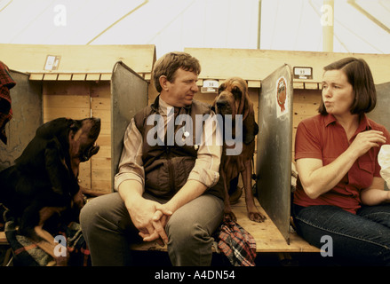 Owners sitting with their dogs at the Bloodhound Competition in Ascot, United Kingdom Stock Photo