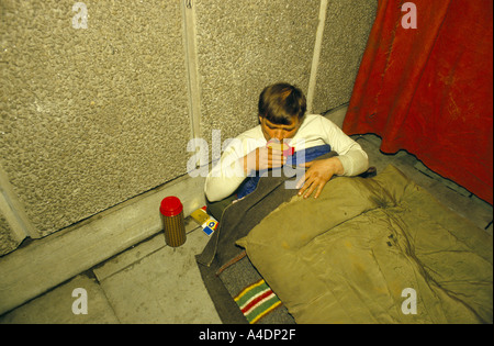 A homeless man drinking a cup of tea from a flask Stock Photo