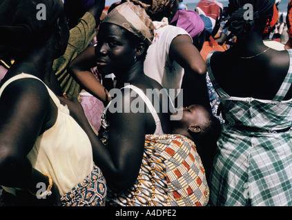 Mother carrying a baby strapped to her back, Accra, Ghana Stock Photo