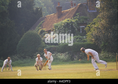 Men playing village cricket, UK Stock Photo