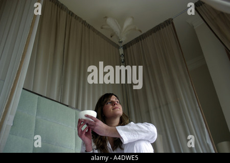 A woman guest in bed at the Grove Hotel in Hertforshire Stock Photo