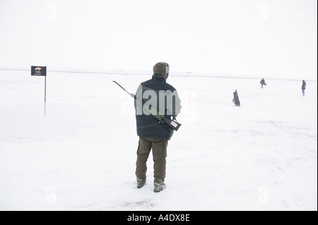 Polar bear spotter with rifle at the 2004 Drambuie ice golf championship in Svalbard, Norway. Stock Photo