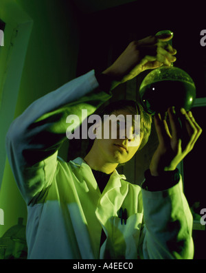 Technician looking at a sample in a laboratory Stock Photo