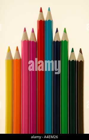 Ten coloured crayons in an arrow shape on a white background Stock Photo