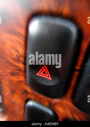 Hazard lights switch on walnut effect car dashboard Stock Photo