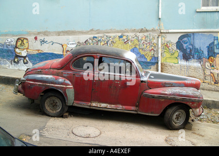 A beat up old car automobile on a back street in Valparaiso Chile s second largest city near Santiago Chile South America Stock Photo