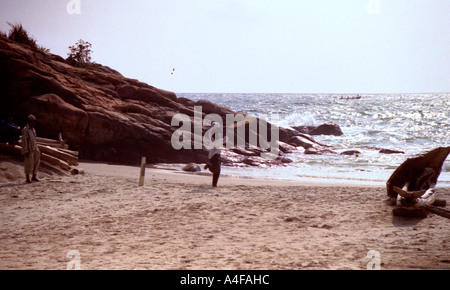 Taking strike in a cricket match on the beach in  Kovalam, Kerala, India Stock Photo