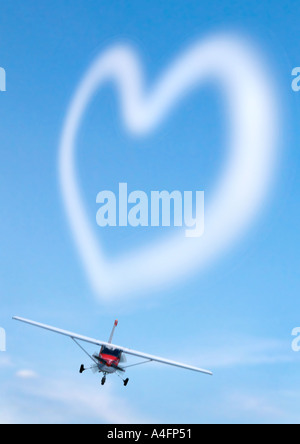 Airplane with heart from clouds Flugzeug mit Herz aus Wolken Stock Photo