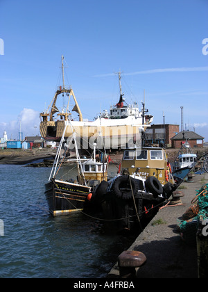 Moored vessels alongside quay in Fleetwood Fish Dock Stock Photo