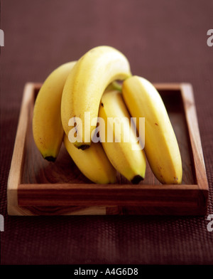 Bunch of bananas on wooden tray Stock Photo