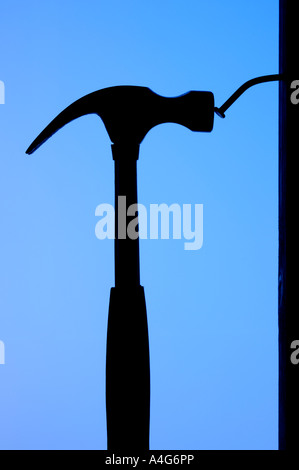 Silhouette of a hammer and bent nail Stock Photo