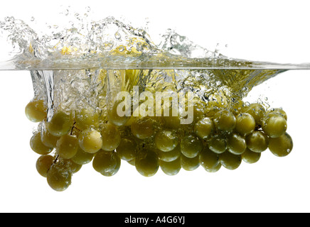 Grapes splashing into water Stock Photo