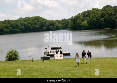 Graduating senior year pupils gather on lawn by lake after Commencement Day ceremony at private high school USA June 2005 Stock Photo