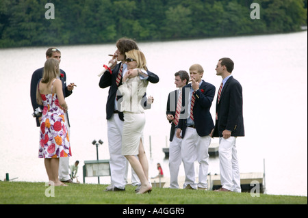 Graduating senior year pupils gather on lawn by lake after Commencement Day ceremony at private high school USA June 2005 Stock Photo