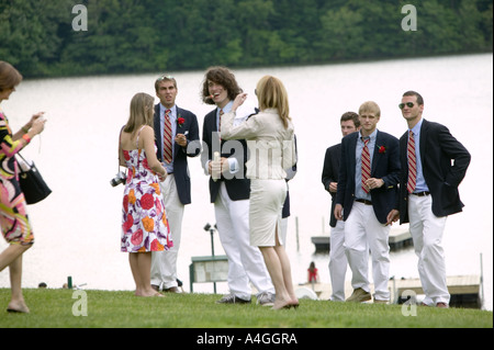 Graduating senior year pupils gather on lawn by lake after Commencement Day ceremony at private high school USA June 2005 Stock Photo