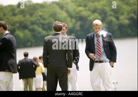 Graduating senior year pupils gather on lawn by lake after Commencement Day ceremony at private high school USA June 2005 Stock Photo