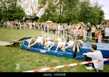 A group of teens performing an acrobatic jump show at a fair in England. Stock Photo