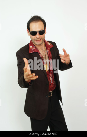 A sleazy looking man gesturing and pointing to camera Stock Photo