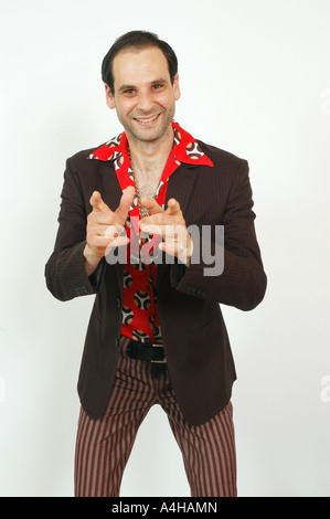 A sleazy looking man gesturing to camera Stock Photo