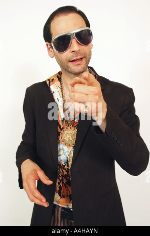 A sleazy looking man gesturing and pointing to camera Stock Photo