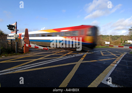 “Level crossing” train crossing a level crossing, Britain UK Stock Photo