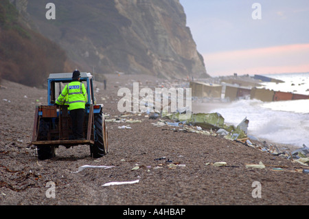 Police patrol the beach after containers were washed up from the MSC Napoli ship, Branscombe Devon Britain UK Stock Photo