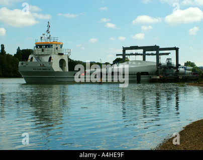 WInd farm turbine blades being transported by river Stock Photo