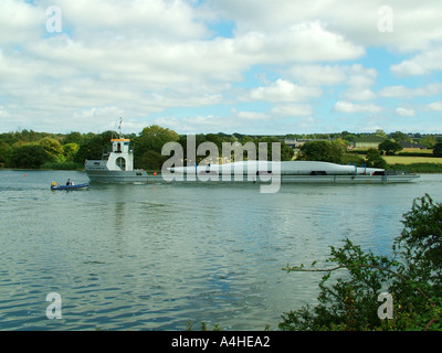 WInd farm turbine blades being transported by river Stock Photo