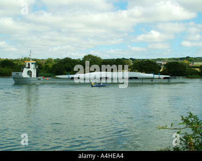 WInd farm turbine blades being transported by river Stock Photo