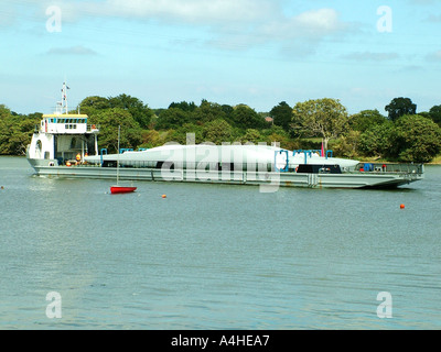 WInd farm turbine blades being transported by river Stock Photo