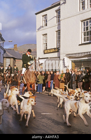 Fox hunt with huntsman blowing horn sets off on traditional Christmas hunt in streets of Crickhowell Powys South Wales UK Stock Photo