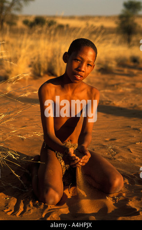 Bushman San boy playing in the sand Kalahari Northern Cape South Africa Stock Photo