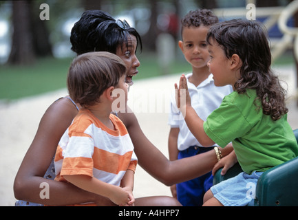 African American teacher with Caucasian and Asian preschool students Stock Photo
