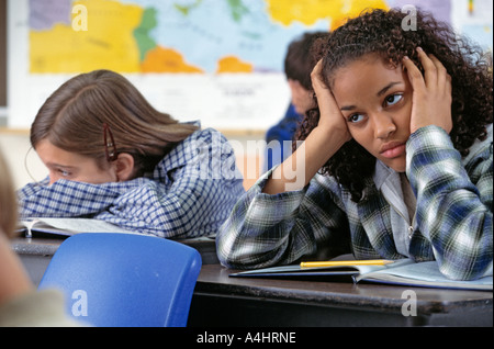African American and Caucasian students in boring middle school class Stock Photo