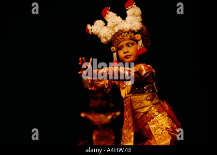 Legong Dancer - Young Balinese Girl dancing Classical Dance Performance and wearing Traditional Costume from Bali, Indonesia Stock Photo