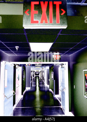 empty hospital corridor leading to emergency room showing EXIT Stock Photo
