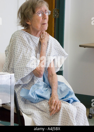 exhausted 80 year old woman resting after a whirlpool wound treatment  session in a hospital rehabilitation center Stock Photo