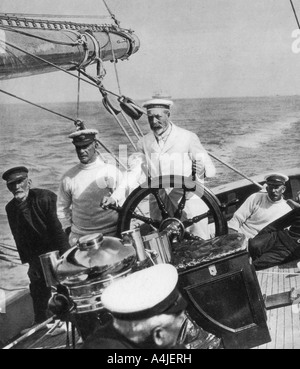 King George V at the helm of his yacht Britannia, c1930s. Artist: Unknown Stock Photo