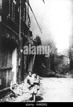 A woman leaving her burning house in a bombed street, Germany, 1945. Artist: Unknown Stock Photo