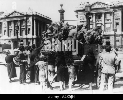 French street sellers offering souvenirs to a truckload of German soldiers, Paris, 27 July 1940. Artist: Unknown Stock Photo