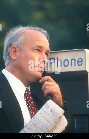 businessman talking on pay phone Stock Photo