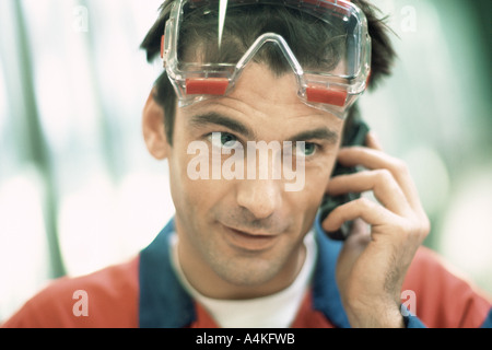Manual worker using cell phone Stock Photo