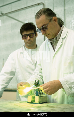 Glass blower forming neon tube Stock Photo