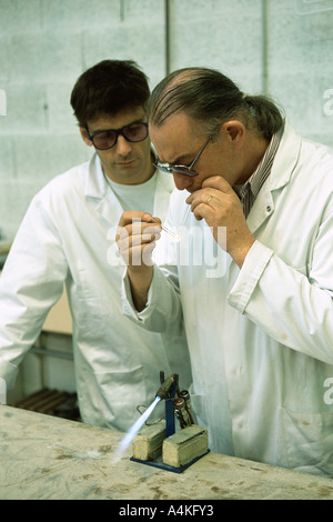 Glass blower forming neon tube Stock Photo