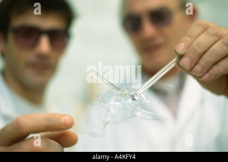 Glass blower forming neon tube Stock Photo