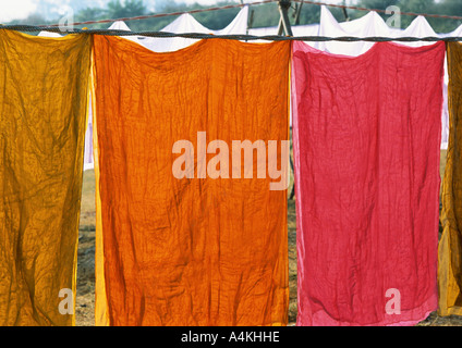 India, Uttar Pradesh, colored sheets hanging on clothes-line Stock Photo