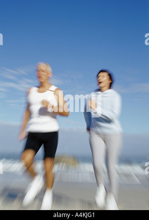 Mature couple running on beach Stock Photo