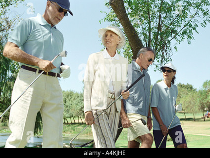 Mature golfers walking side by side Stock Photo